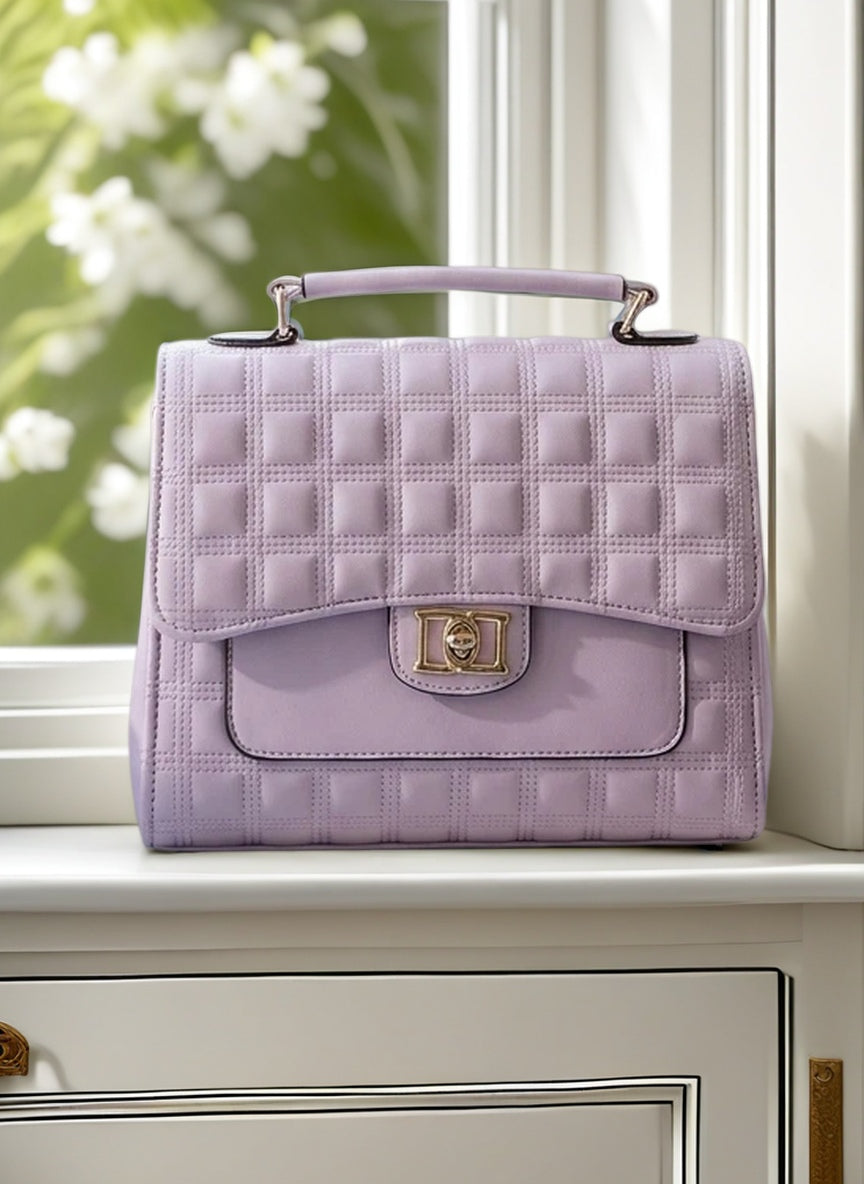 Quilted purple handbag on a surface with a blurred floral background
