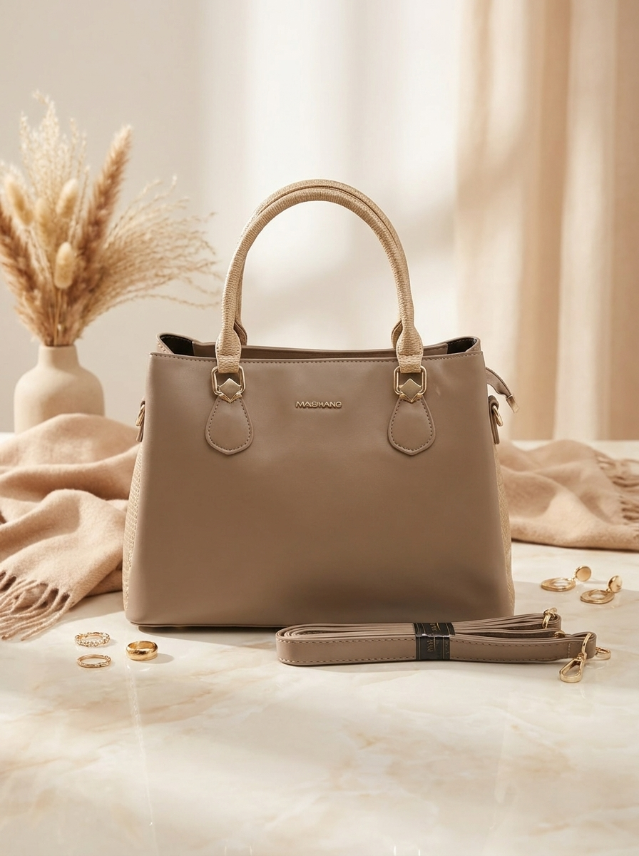 Beige handbag with a detachable strap on a light background