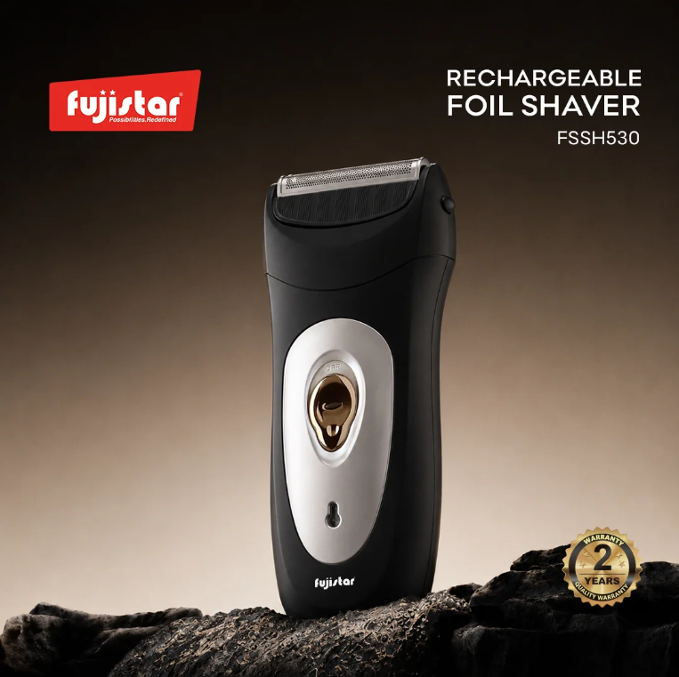 Fujistar rechargeable foil shaver FSSH530 in black and silver, standing upright on a dark textured surface against a dark brown gradient background, with Fujistar branding and a 2-year guarantee badge.
