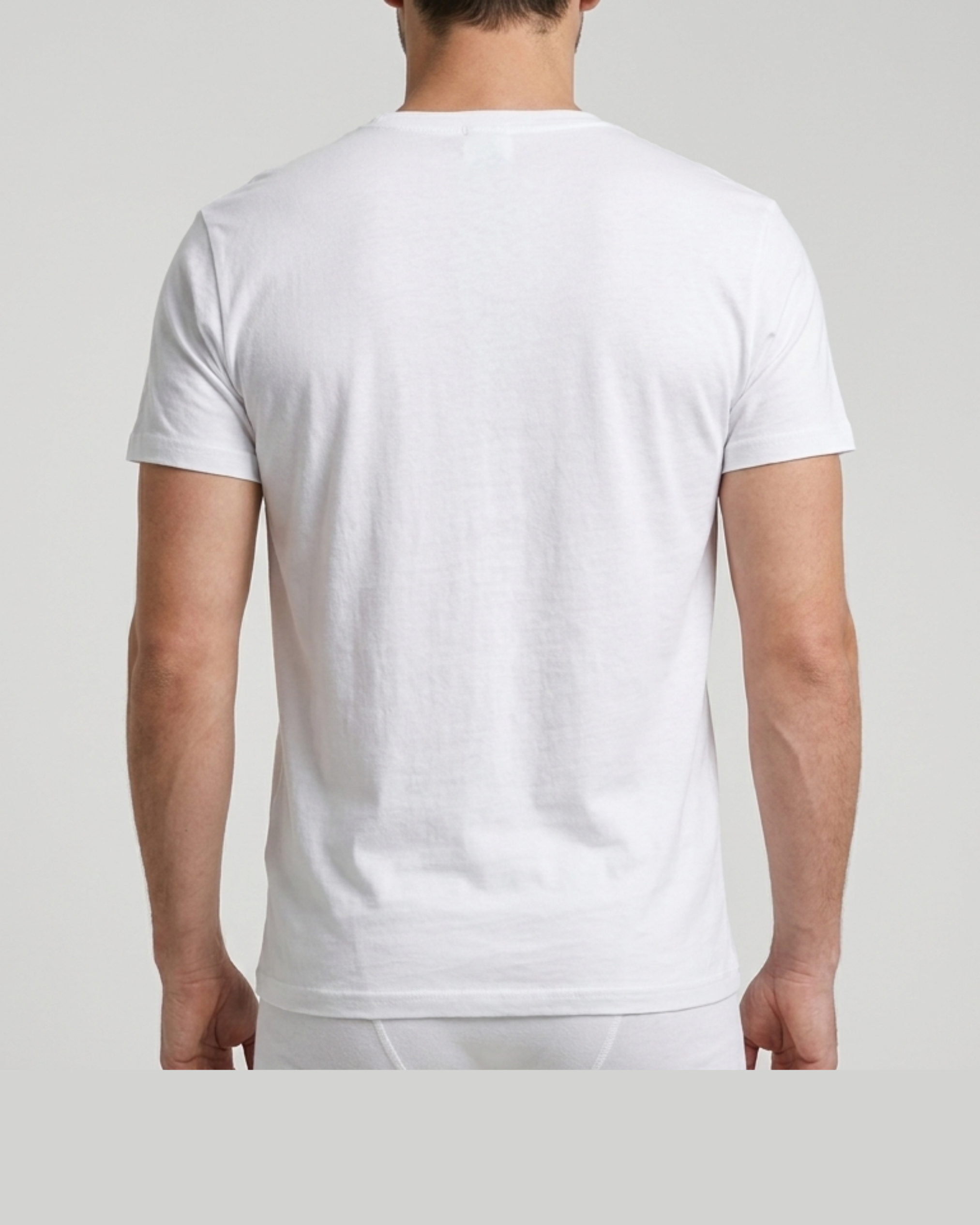 Person wearing a plain white t-shirt on a light gray background