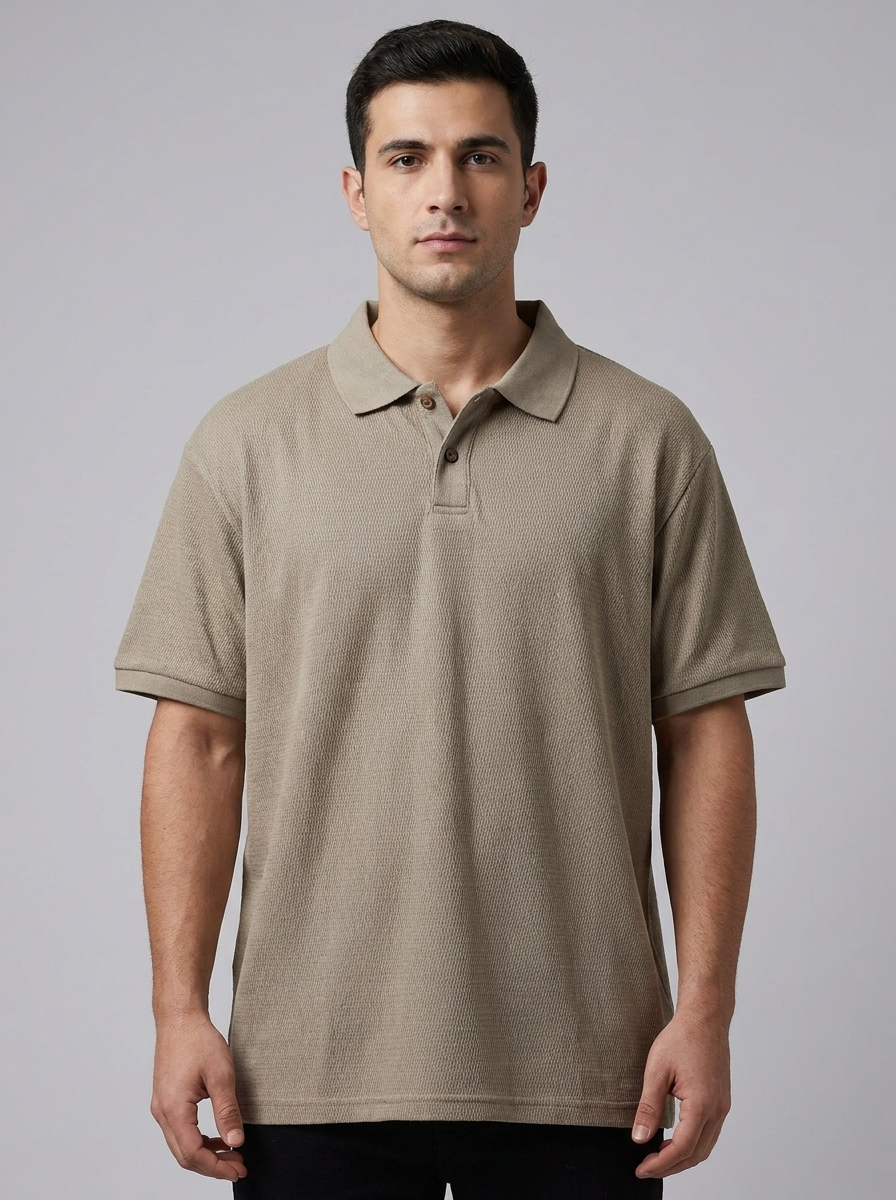 Man wearing a beige polo shirt against a gray background