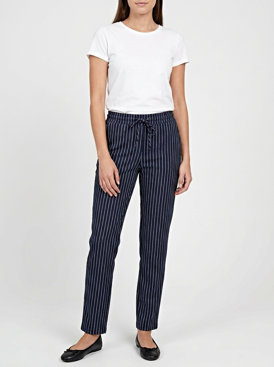Person wearing a white t-shirt and navy pinstripe pants on a white background