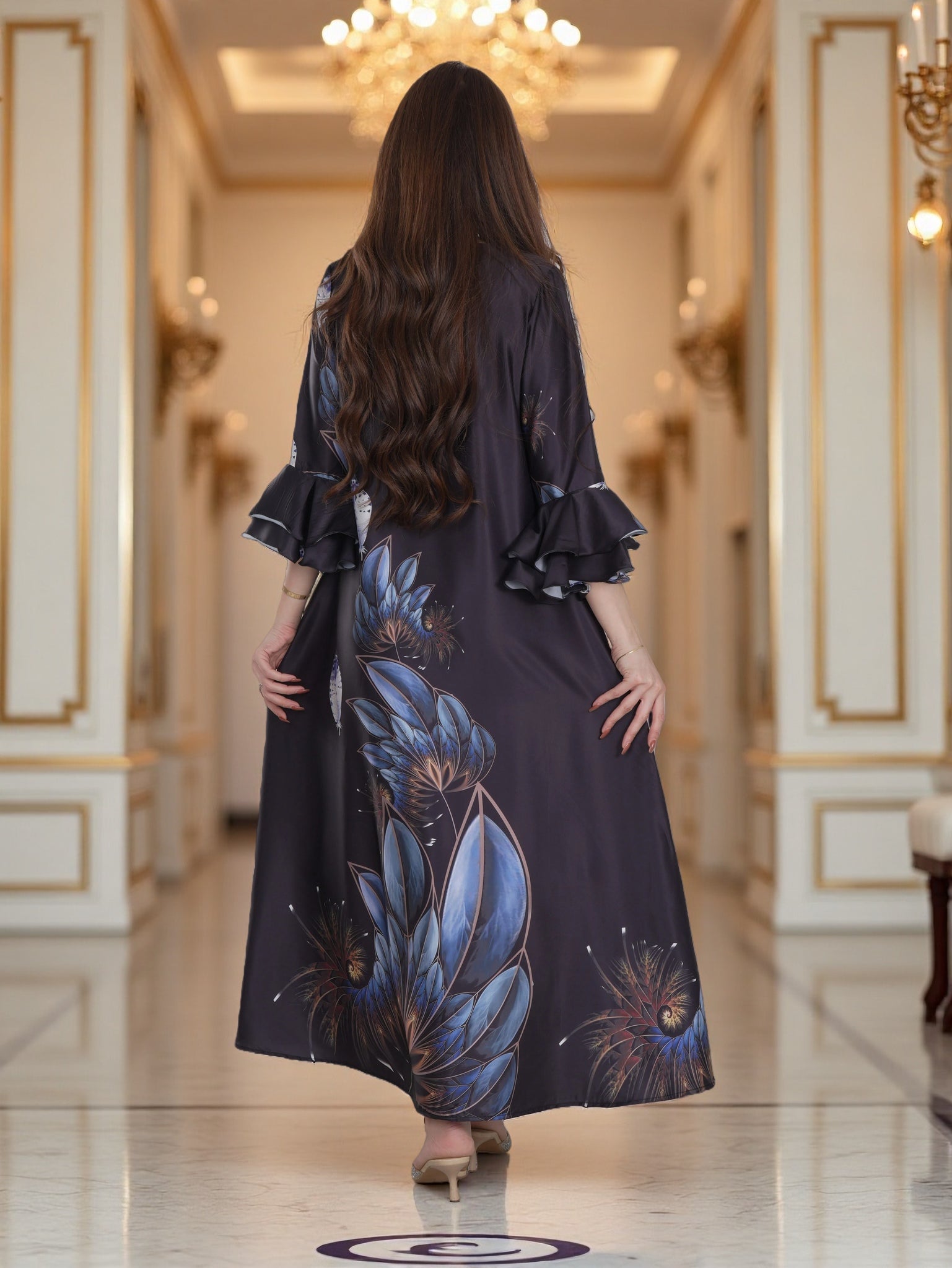 Woman in a long, dark dress with floral patterns walking in an elegant hallway.