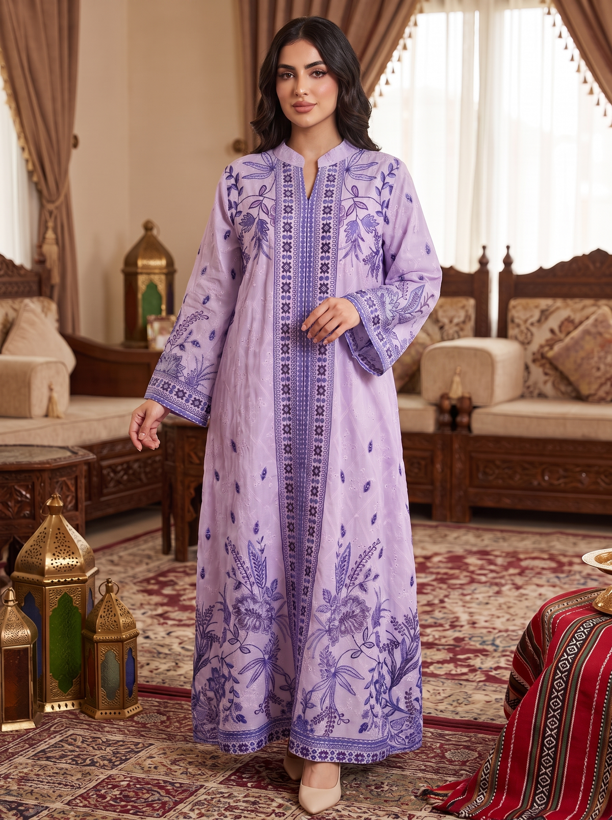 A woman models a lavender purple long kurta with detailed floral embroidery and geometric borders, set in an ornate traditional room with wooden furniture and patterned rugs.
