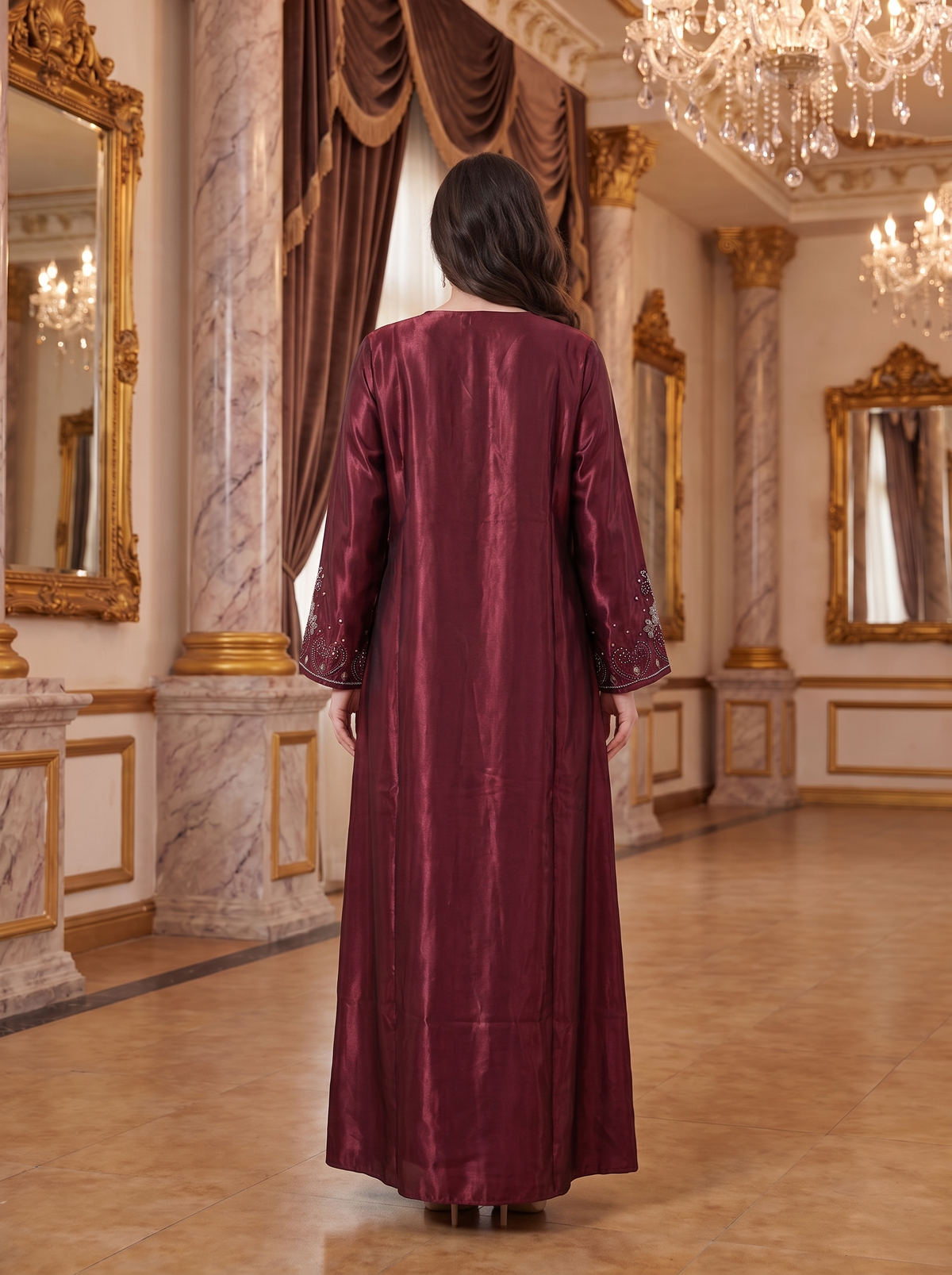 A woman viewed from behind wearing a long, floor-length maroon abaya with embroidered cuffs, standing in an opulent, classical hall with marble columns and gold-framed mirrors.