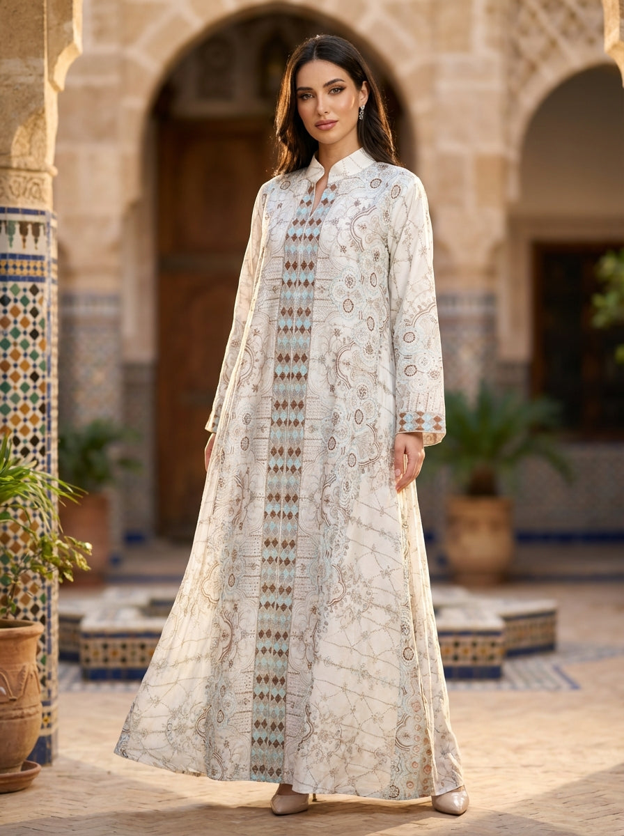 Woman in a long, patterned Jalabiya dress standing in an outdoor setting with arches and plants.