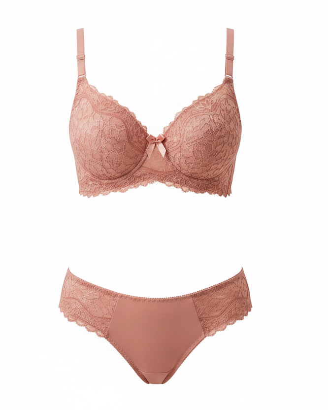 Woman wearing a pink lace bra and panties set on a beige background