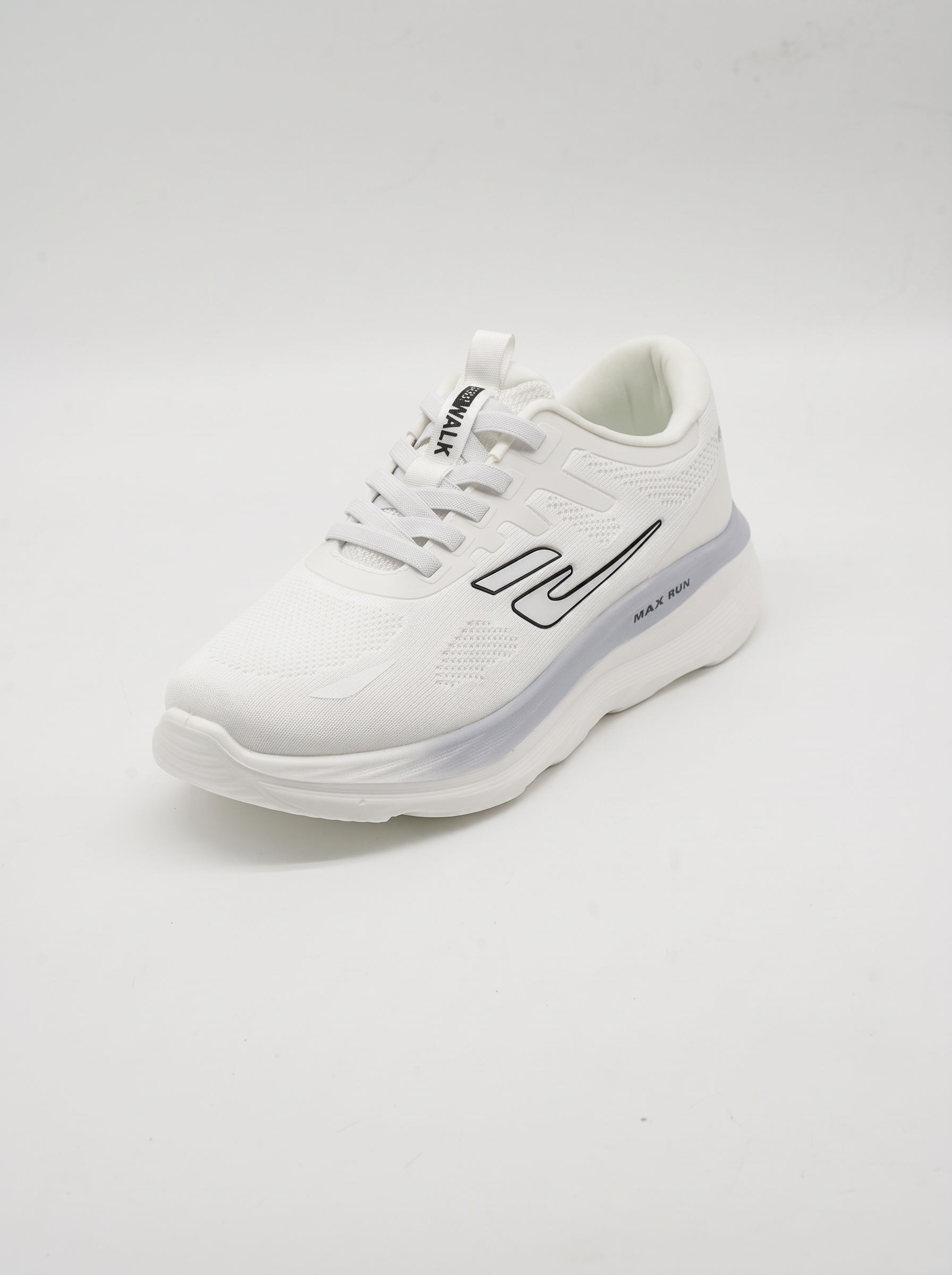 A white athletic sneaker with black and gray logo accents, shown from a three-quarters angle on a light gray studio background.
